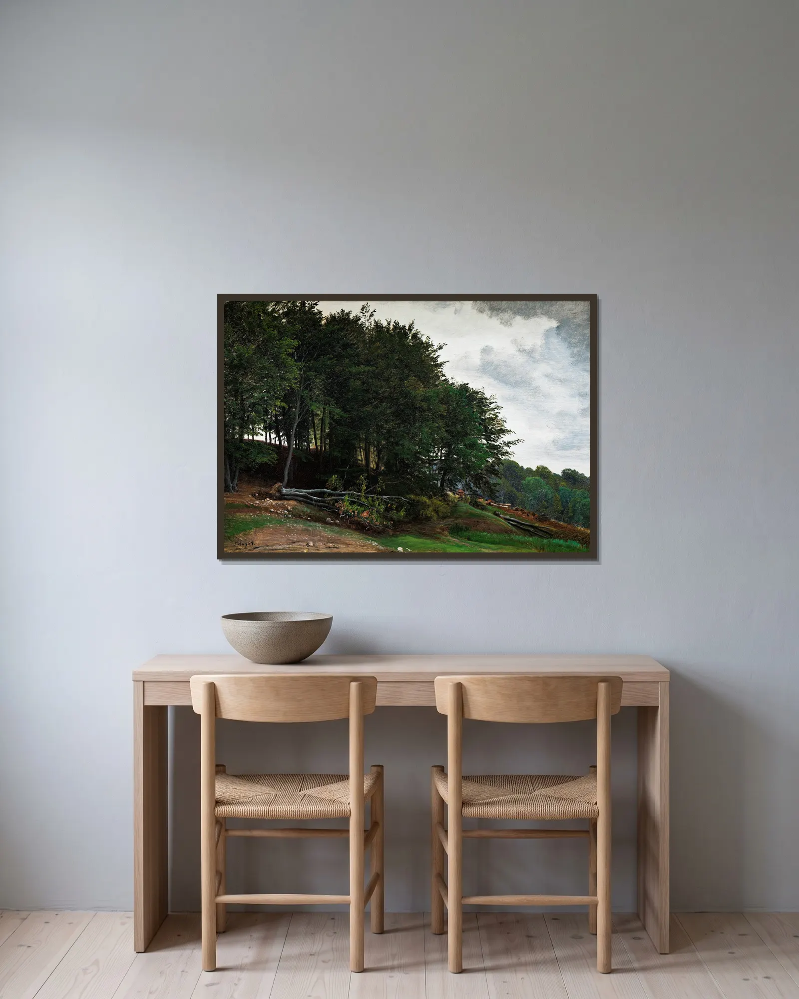 Forested hills av P. C. Skovgaard inramad på en vägg