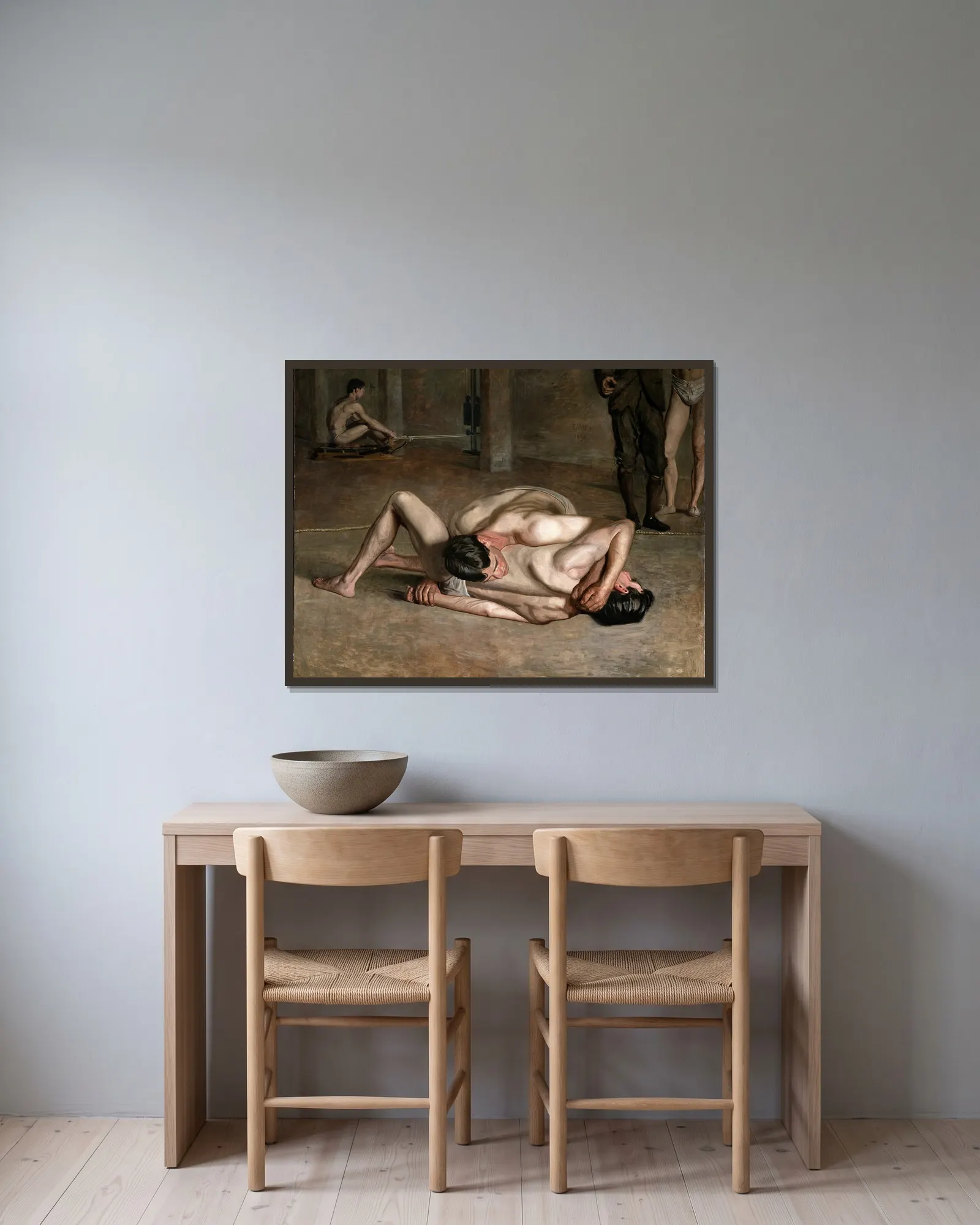 Wrestlers av Thomas Eakins inramad på en vägg